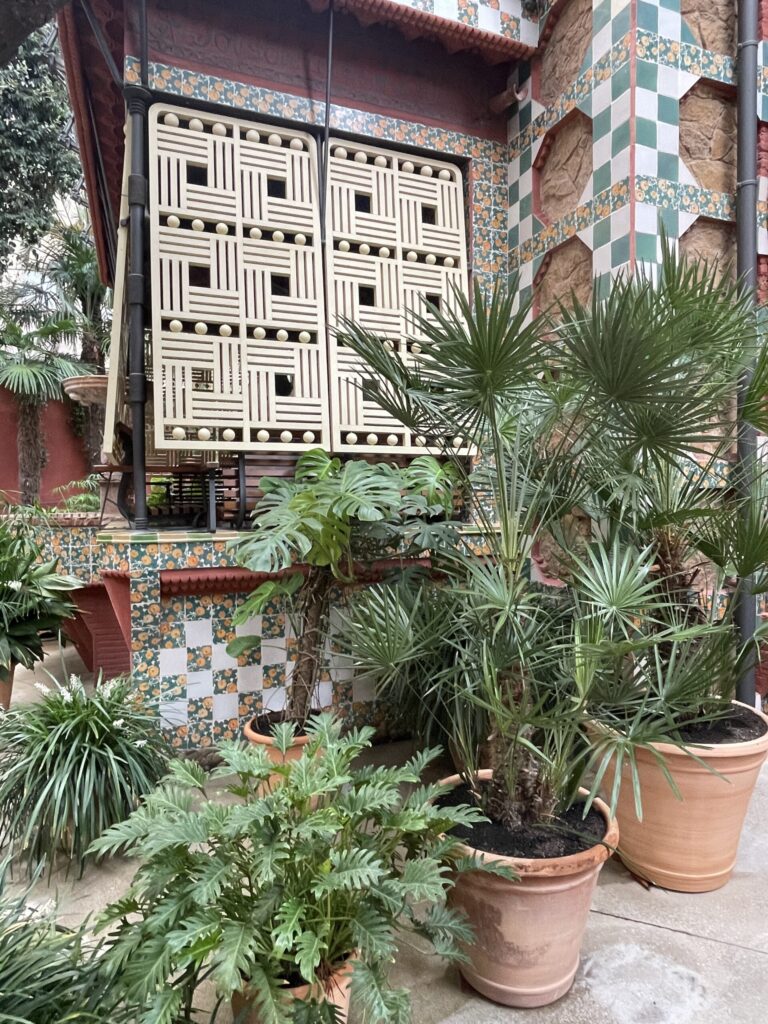 Garden gallery and geometric wooden shutters at Casa Vicens